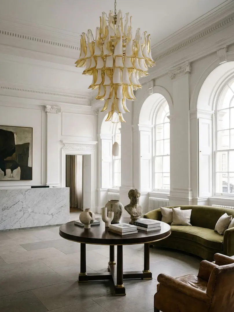 85 lattimo leaves Murano chandelier hanging in a hotel lobby