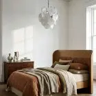 24 white alabaster Murano disk chandelier hanging in a bedroom