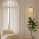 5 tube white alabaster wall light hanging in livningroom
